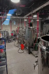 Brewery equipment in industrial interior setting.