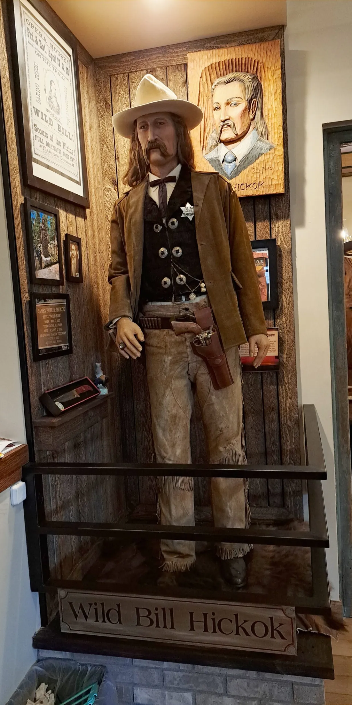 Statue of cowboy in historical museum display.