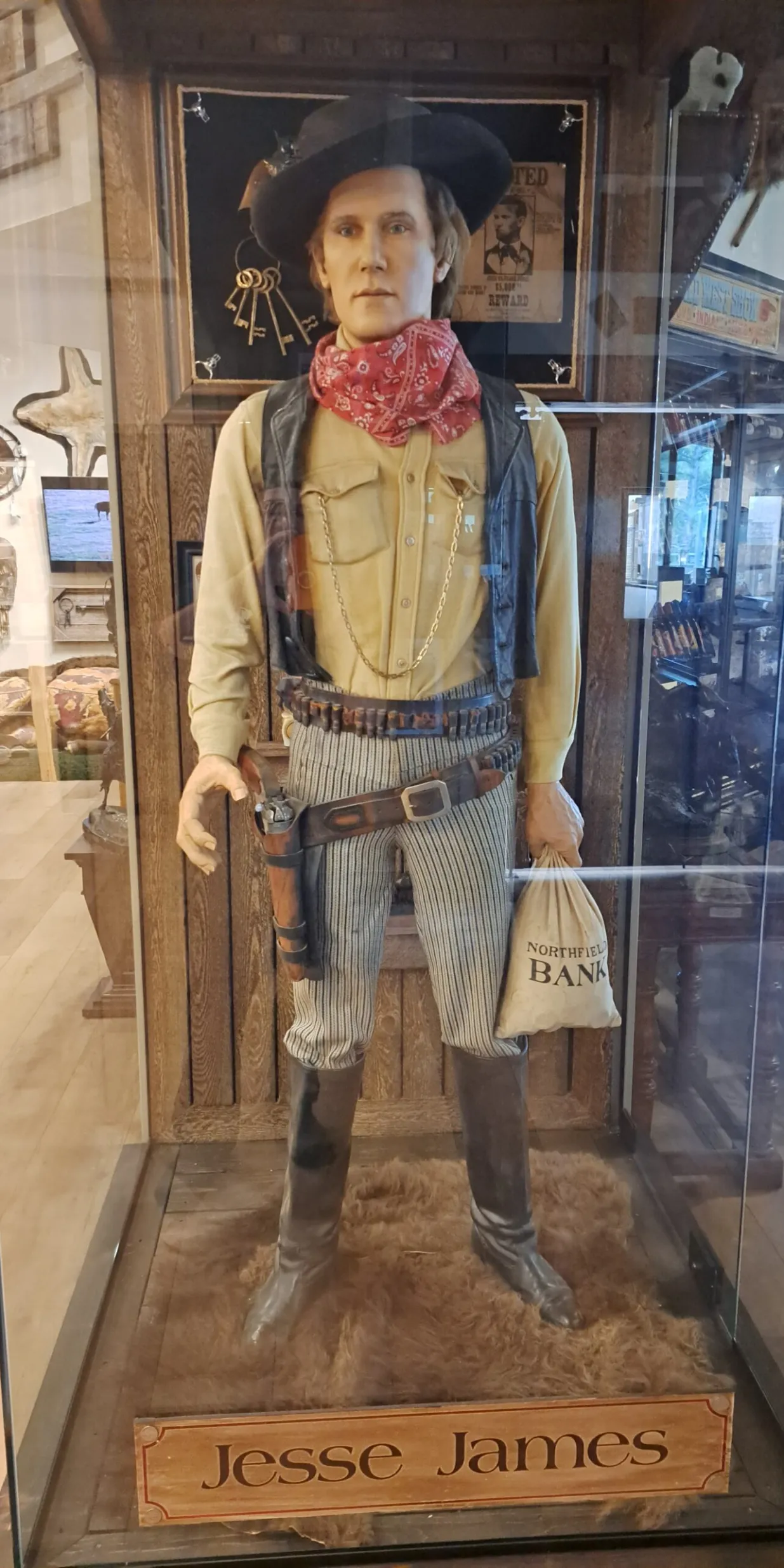 Cowboy statue in Western-themed display case.