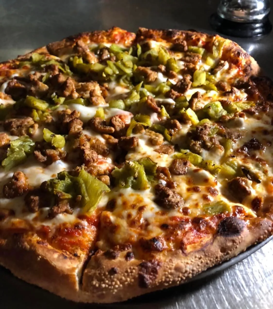Pizza with sausage and green peppers topping.