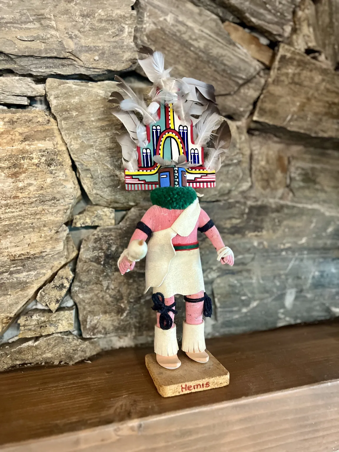 Colorful kachina doll with feather headdress.