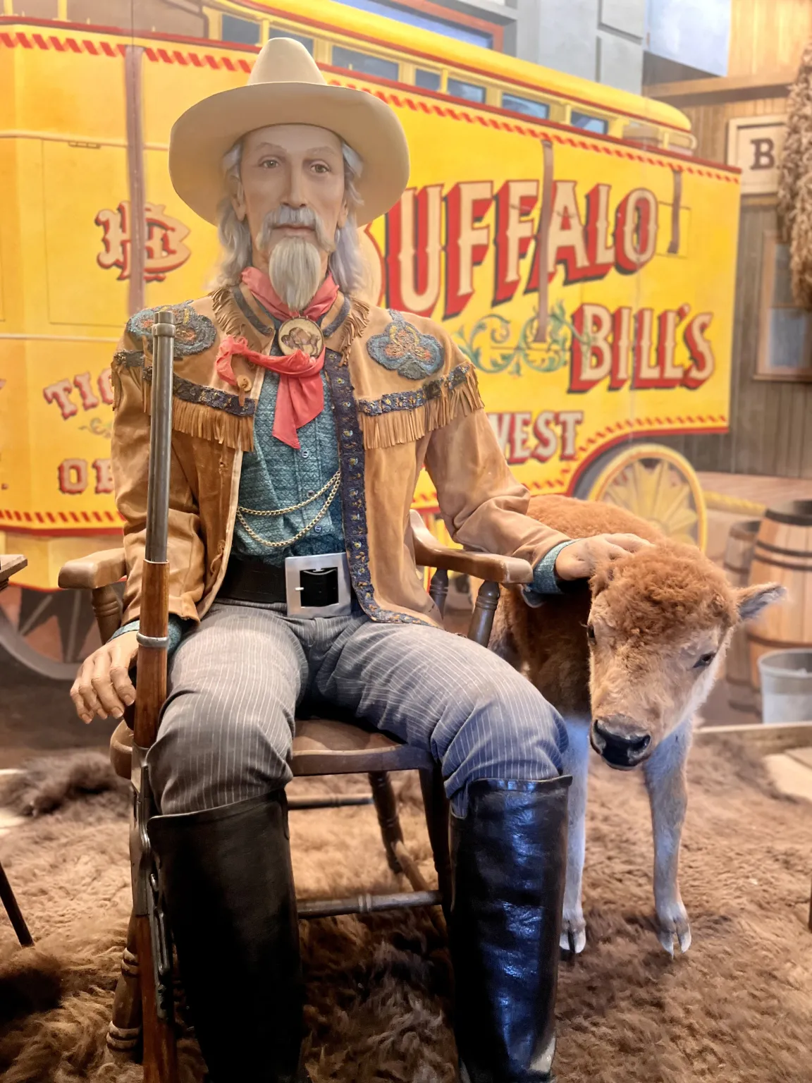Cowboy figure with bison, Buffalo Bill's backdrop.