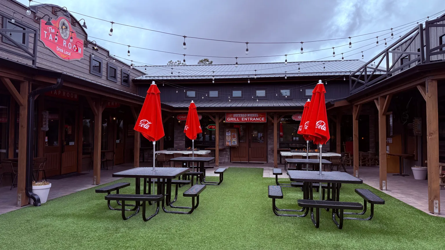 Outdoor seating area with red umbrellas.
